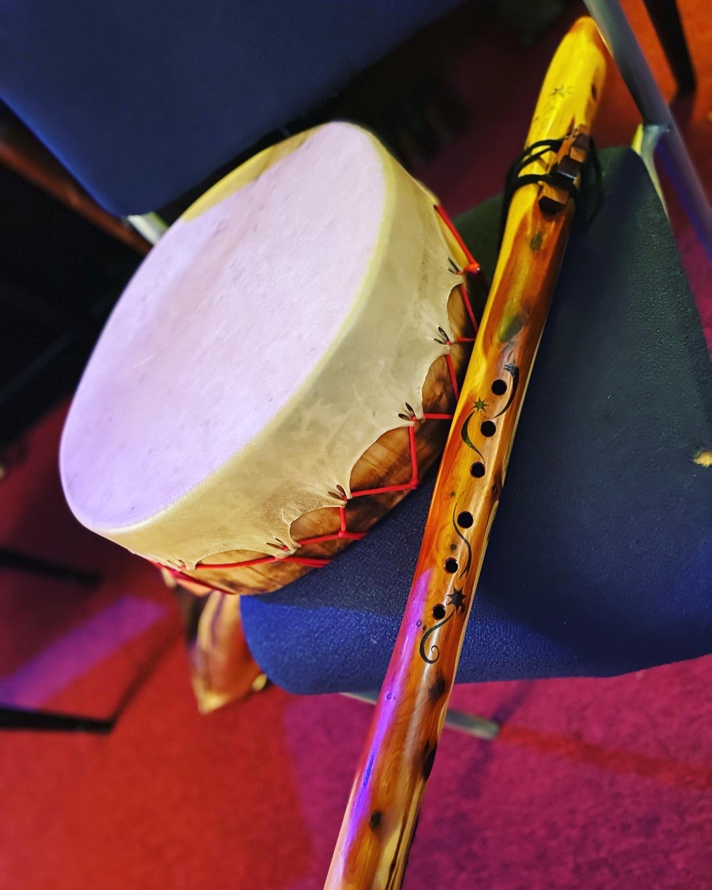 Hand drum and carved wooden flute — sacred ceremonial instruments used in Indigenous plant medicine ceremony by Dr. Courtni Hale